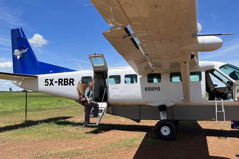 Tourist boarding a small safari plane for a fly-in safari to Kidepo Valley National Park